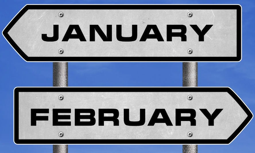 Image is a blue back ground with two signs. One saying January pointing backwards, the other February, pointing forward.